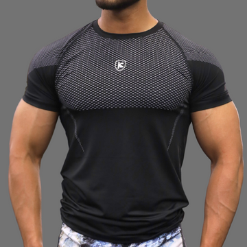 Man wearing a black athletic shirt with a logo on a gray background